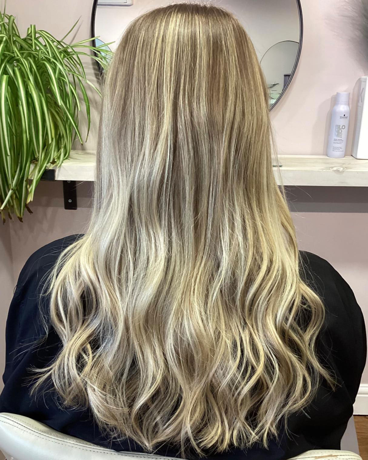 An after image of a clients long blonde hair once cut